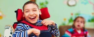 child in wheelchair laughing
