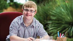 Young man with disability doing school work