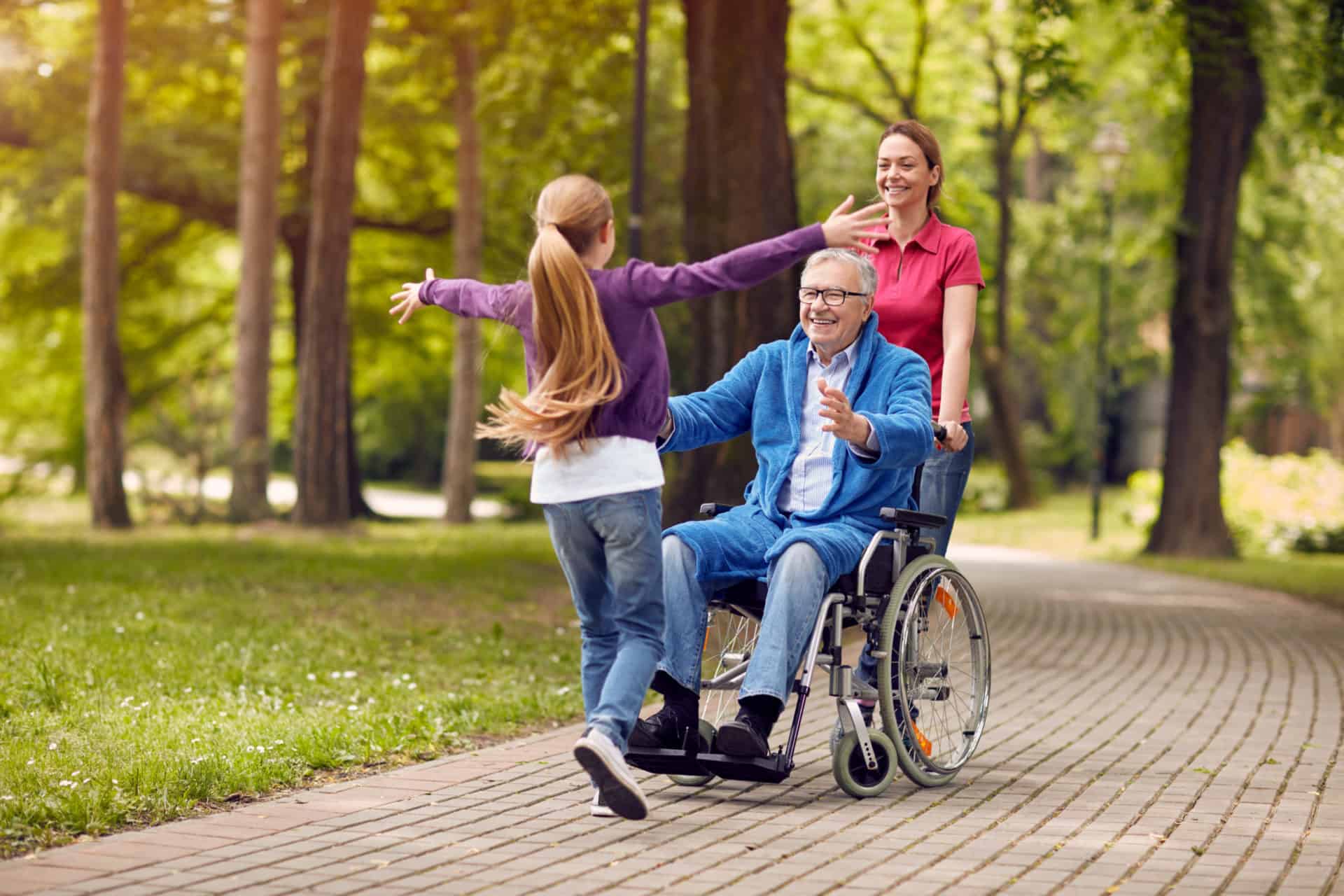 Cheerful,Disabled,Grandfather,In,Wheelchair,Welcoming,His,Happy,Granddaughter