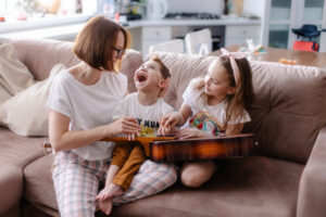 Beautiful portrait of a family with a disabled child. Playing guitar